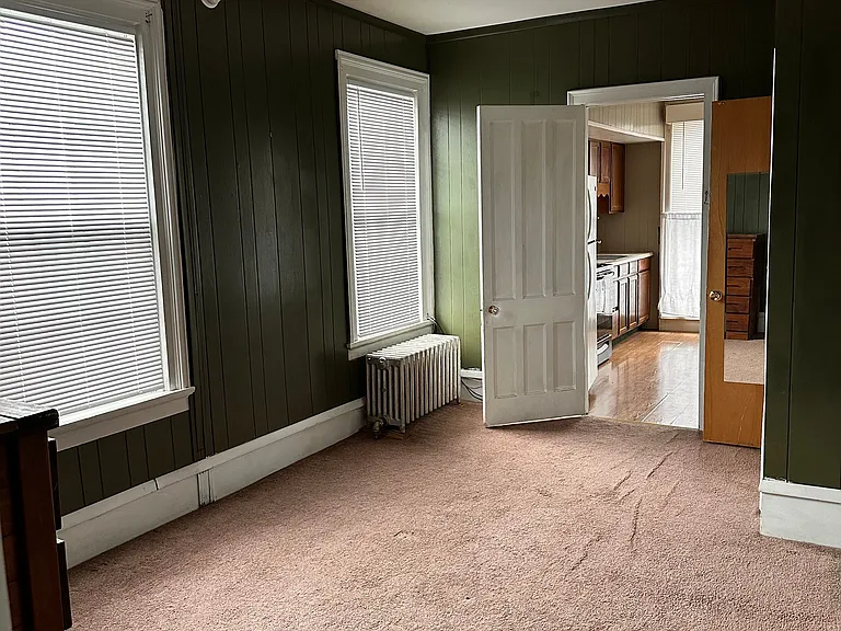 Large bedroom with two closets and large window.