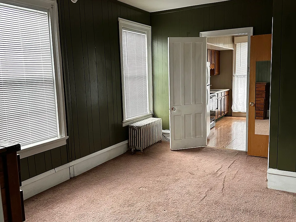 Large bedroom with two closets and large window.