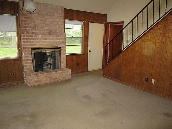 Den17x13Fireplace and great views of the backyard