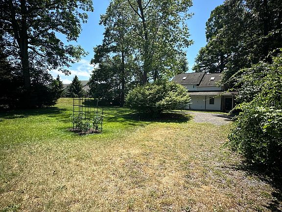 Large private yard with garden and circular drive.