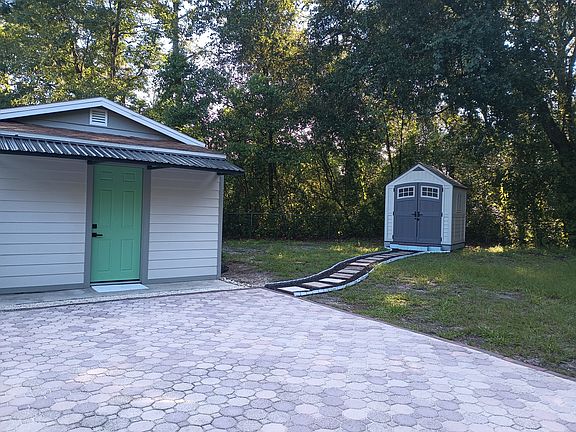 Back Patio / Back Door / 8x10 Shed with 2 6 ft. floor to ceiling shelving units