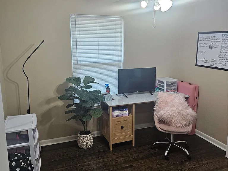 Office featuring dark wood-type flooring and ceiling fan