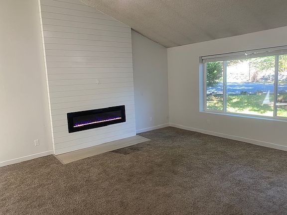Chic electric fireplace provides a warm, colorful ambiance in one of two living areas.