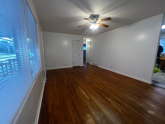 Large living room with hardwood floors and freshly painted interior.