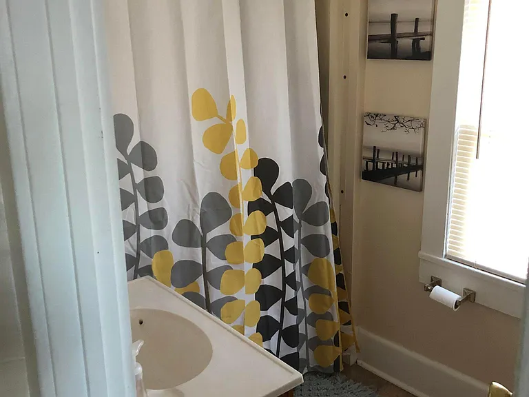 Full bath, toilet vanity in back hallway off back of kitchen near table area.