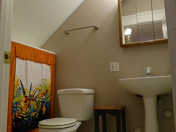 Bathroom - toilet and sink (tub/shower to right of sink).