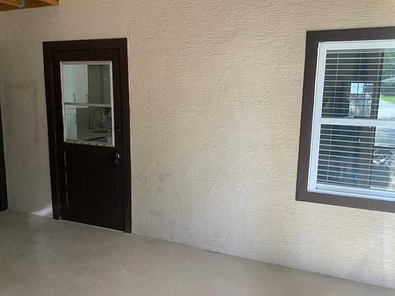 Front Door inside covered entry. Dining room is behind right window.