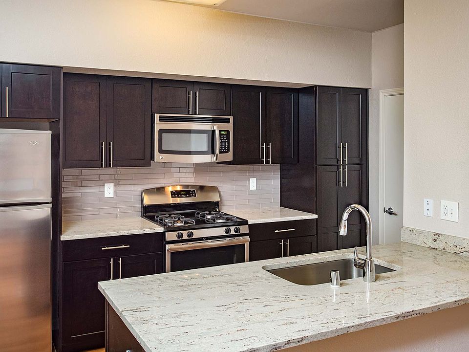 Modern kitchen with stainless steel appliances, granite countertops and premium cabinetry