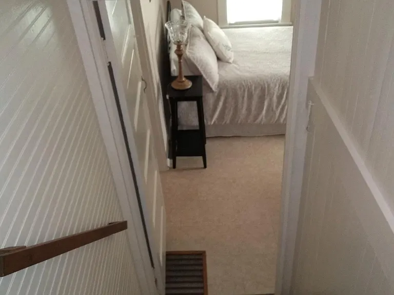 Cute staircase looking into main level bedroom.