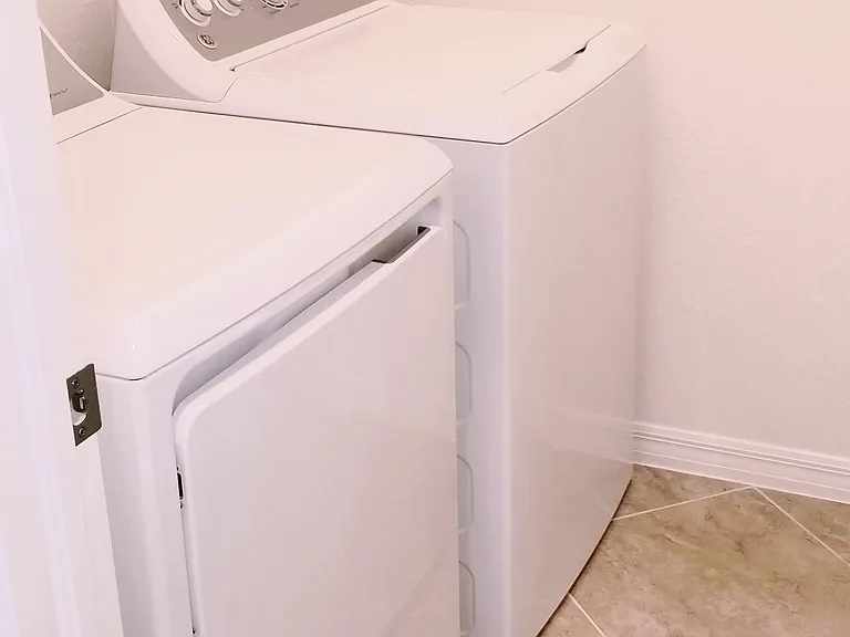 Full size Washer Dryer in roomy Laundry room with extra selves for Convenience.