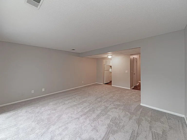 Spacious living room with carpet