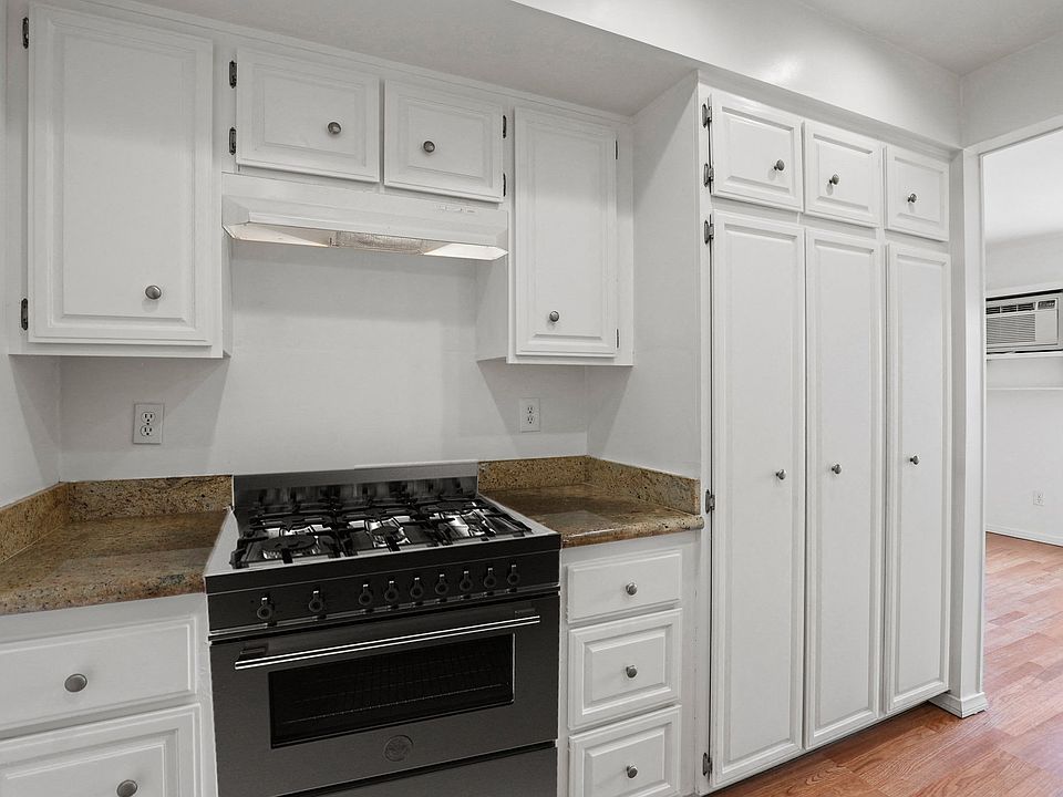 Kitchen with Stainless-Steel Stove and Ample Cabinet Storage