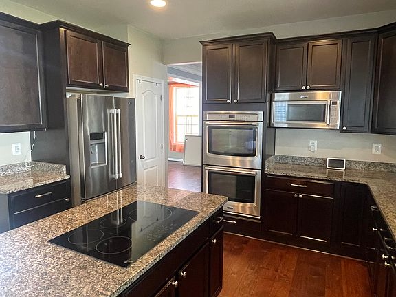 Double oven, microwave, new induction stove. Plenty of cabinet space, and granite countertops+island
!