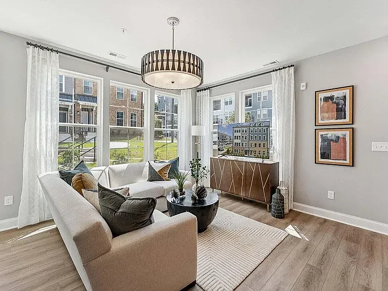 Natural light fills the modern living room, offering a bright, inviting space with room for all your furniture.