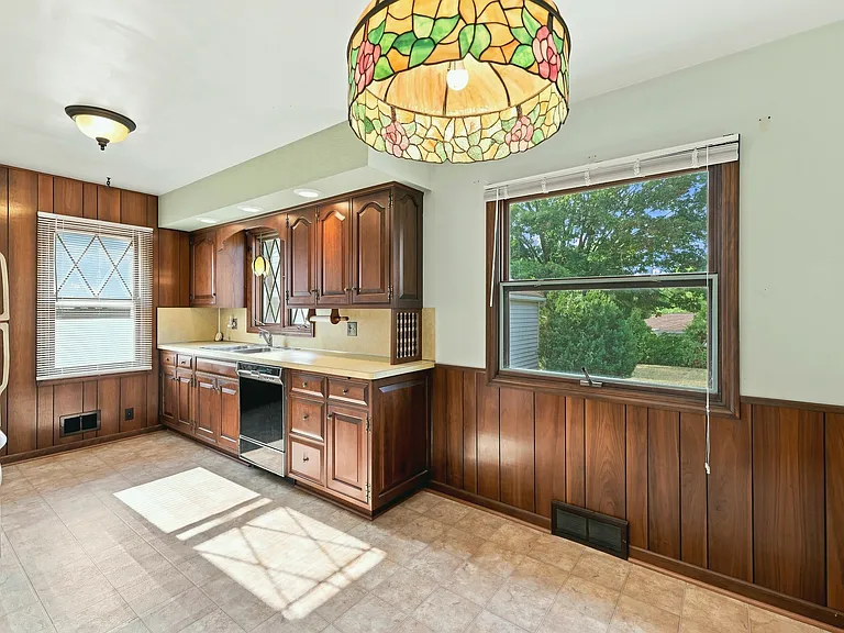 Beautiful timeless kitchen with new floors, immaculate-condition cabinets, big window, and a dishwasher just that won't quit!