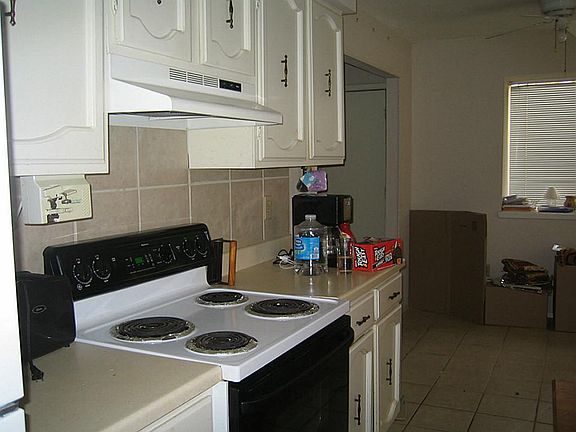 Kitchen has tile back splash and floor. Refrigerator is negotiable.