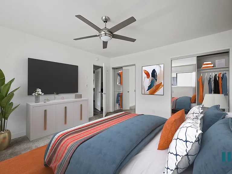 Bedroom with Two-Mirrored Closets, Ceiling Fan, and Carpet
