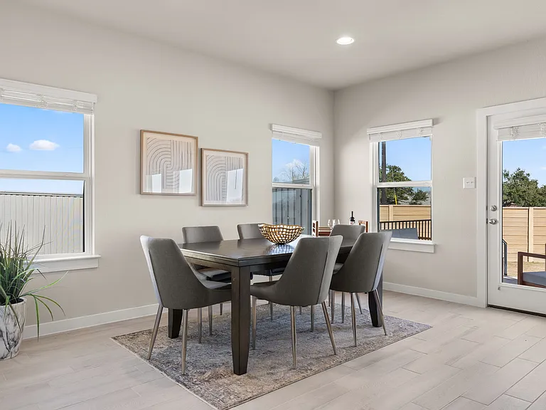 Dining area has plenty of space for large or small dining table surrounded by windows.