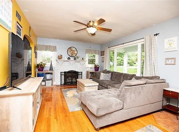 Living room is filled with sunlight, wood floors and great living space complete the space.