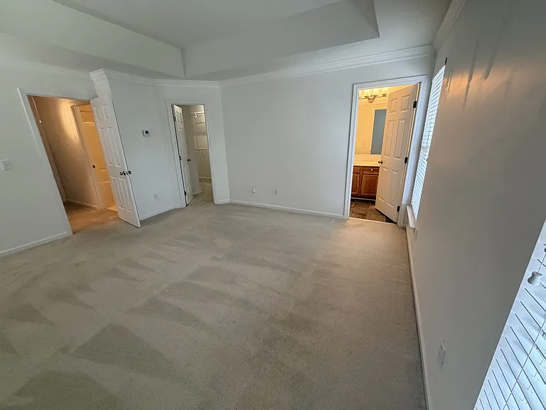 Master Bedroom with tray ceiling, master bathroom and large walkin closet