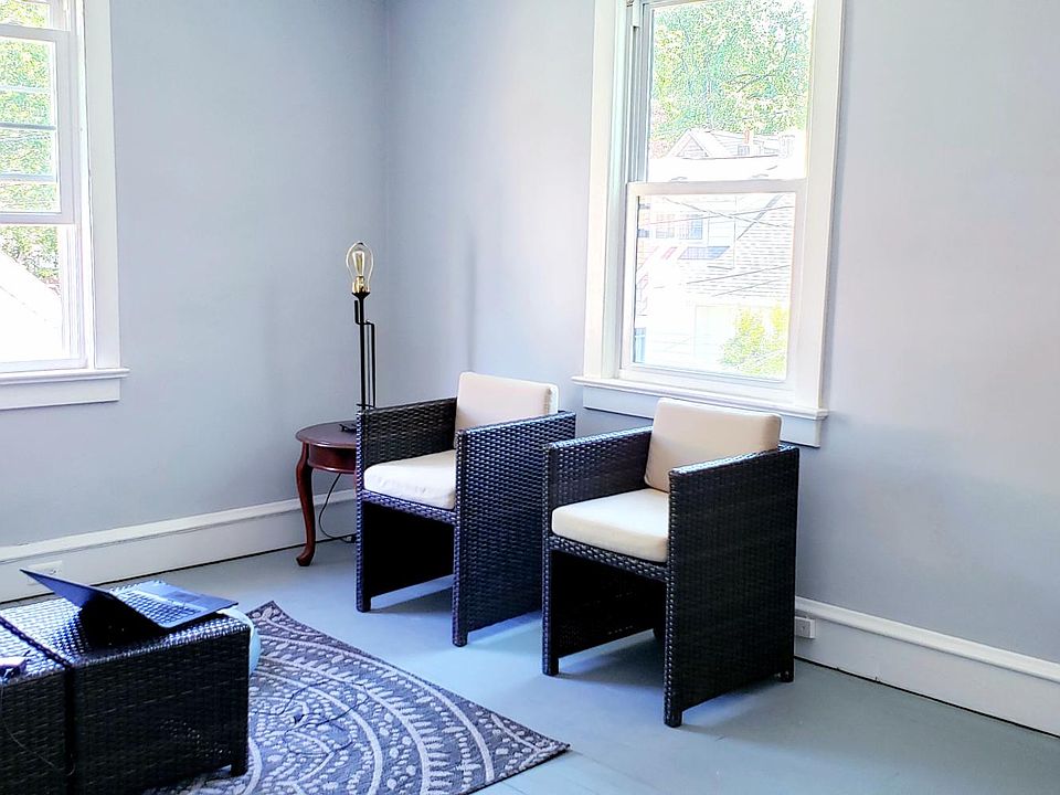 Light filled living room, newly painted with new windows throughout.