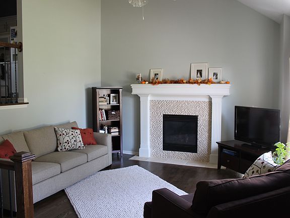 Living, new tumbled marble tile surround on fireplace
