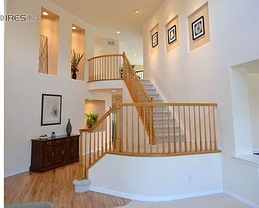 Curved staircase overlooking the foyer.