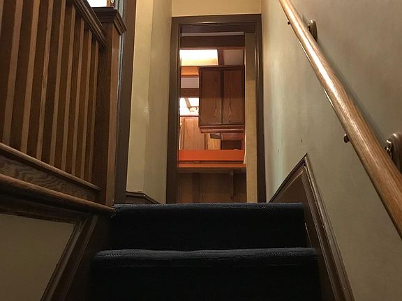 Looking up steps towards 2nd fl kitchen ahead and bathroom to left.