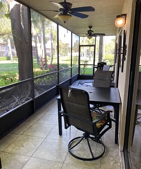 large screened patio with table and chairs