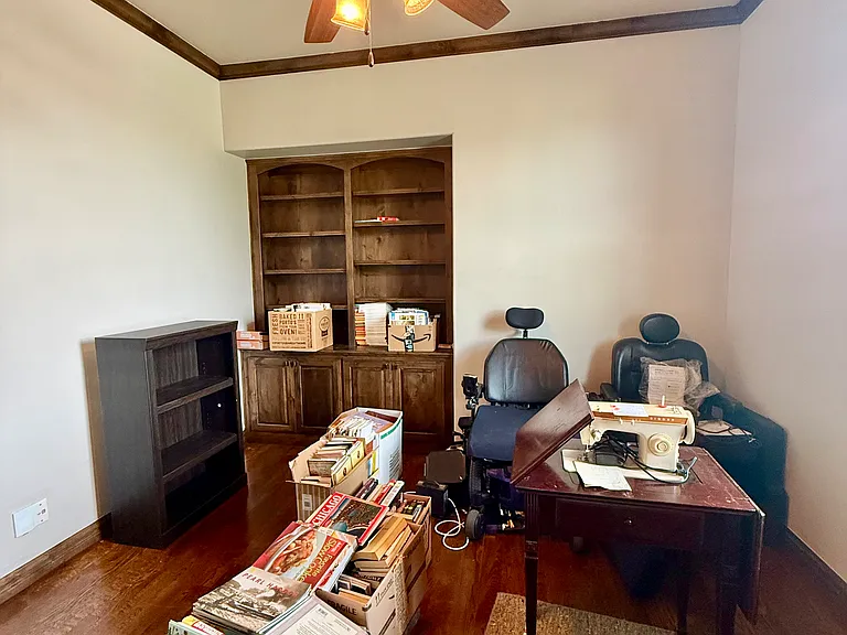 Please forgive the items in the room. This picture will be replaced later. This is to show the bookshelves and storage underneath the shelving.