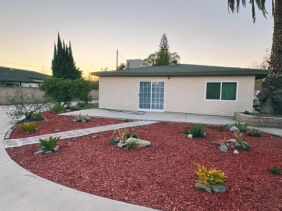 Backyard with new drought tolerant landscaping and several fruit trees including apple, orange, lemon, lime, and grapefruit.