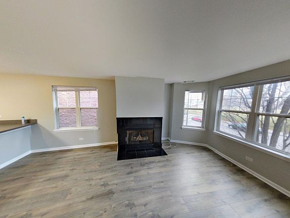 Living Room, new hard floors, with Gas Fireplace facing Divi