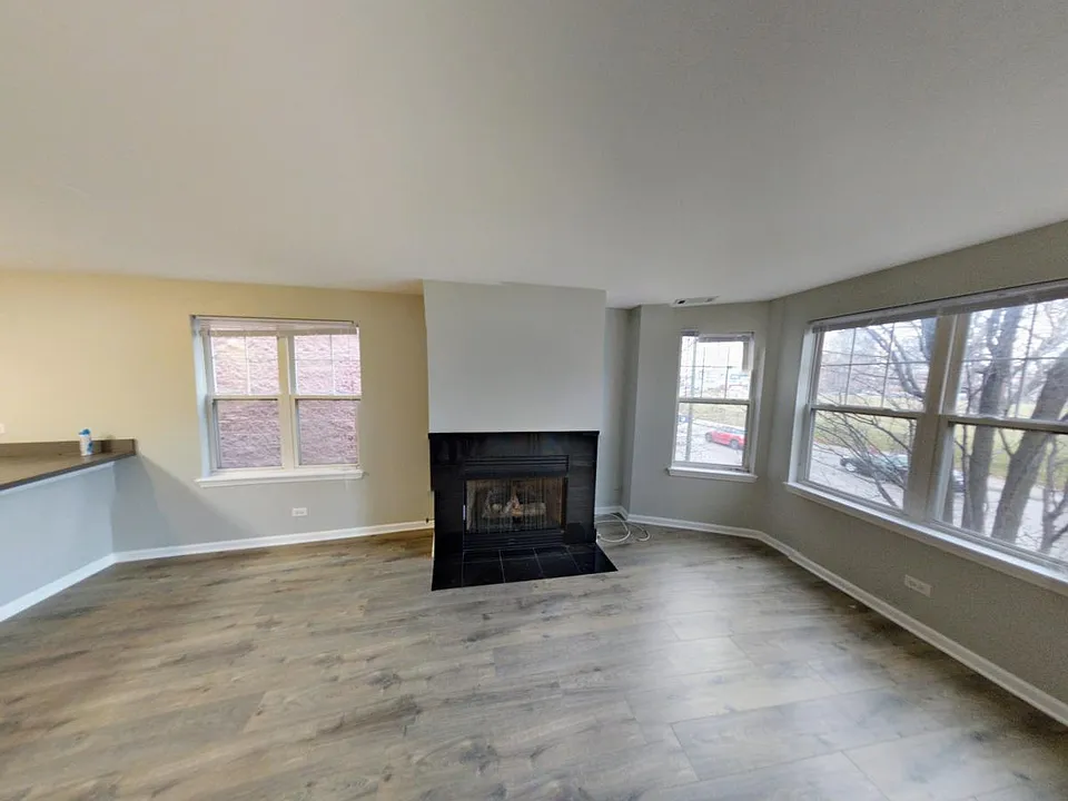 Living Room, new hard floors, with Gas Fireplace facing Divi