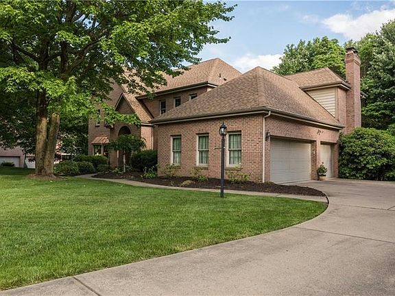 3 car attached garage with level concrete driveway featuring large turnaround.