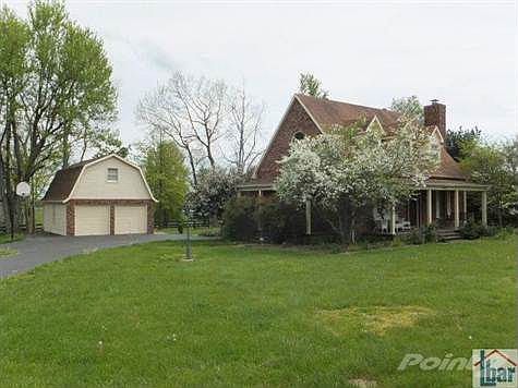 Custom built 1.5 story home and two story garage on 5 beautiful acres just 3 miles from town close to Lexington. Home has 4 porches.