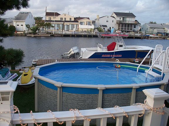 above ground pool & floating dock on lagoon
