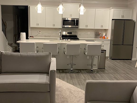 Open-concept layout connecting the kitchen, island, dining area, and main living space.