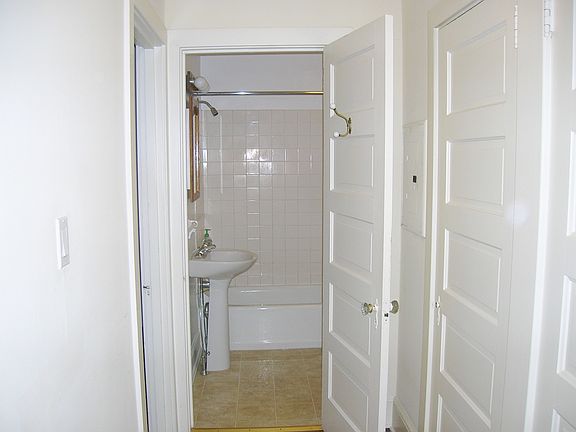 bathroom has tub and storage