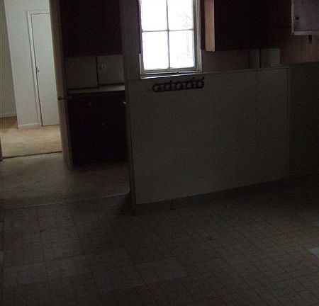 From the living room through the dining room can you guess what is behind that half wall?