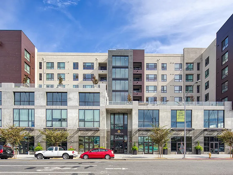 Street_level exterior showcasing large windows, clean architectural lines, and a welcoming entry framed by greenery.