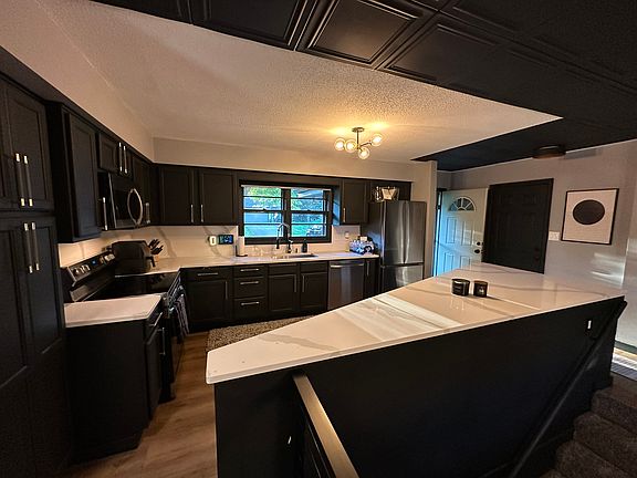 Quartz countertops and full quartz backsplash. The custom cut island is provides expansive countertop space for entertaining.