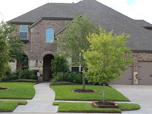 Mature landscaping, and inviting front entry with covered porch!