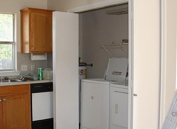 Kitchen with dishwasher and laundry closet including hot wat