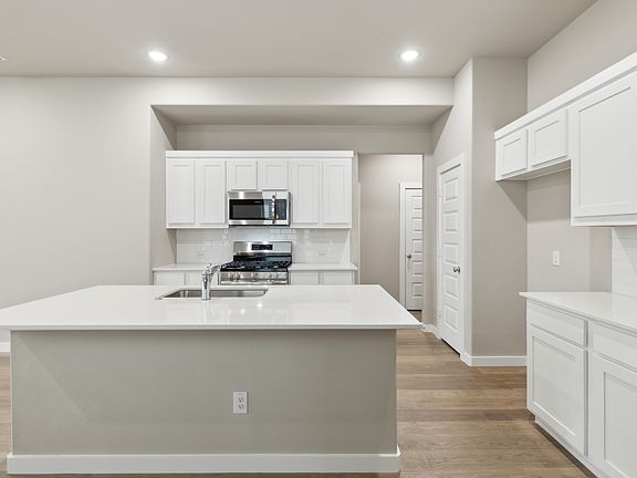 Kitchen in the Elm home plan by Trophy Signature Homes - REPRESENTATIVE PHOTO