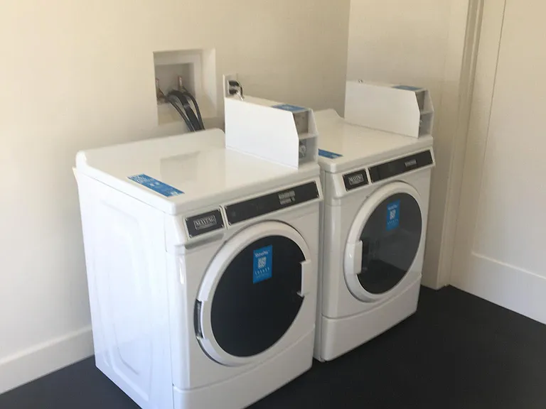 Smart phone operated new commercial washer and dryer. Shared by tenants in both buildings.