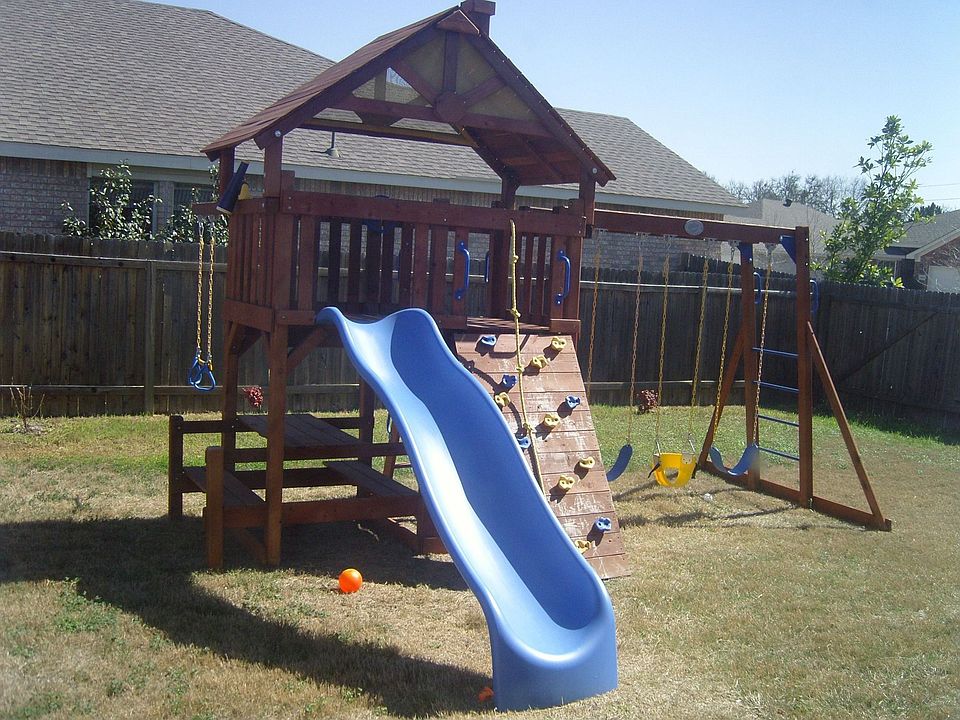 swing set in fenced yard