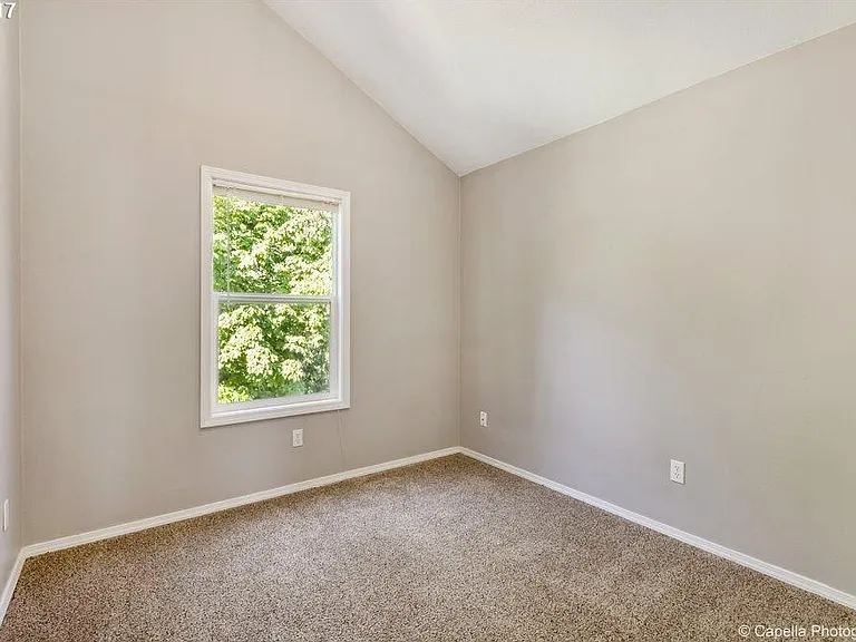 Second Bedroom on upper level also has vaulted ceilings and overlooks the beautiful green space/creek behind .