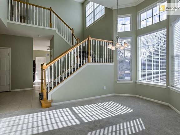 This home features dramatic 12' ceilings and open staircase - look at all the light coming in! Notice the bay window in the dining area.