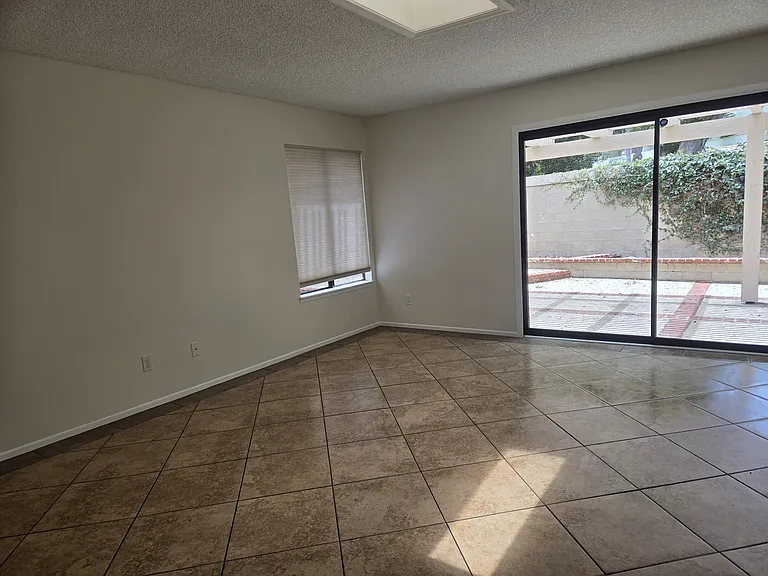 Spacious den leading to rear patio.