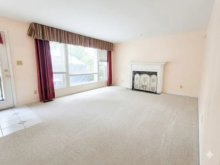Family room with gas fireplace. You can see a deck through the window.